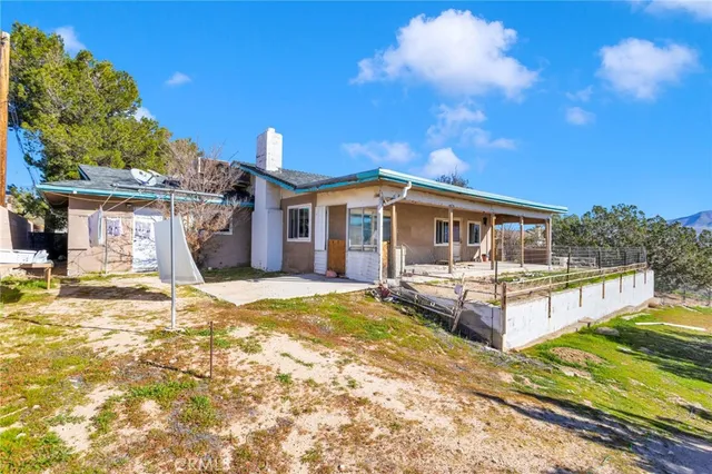a view of a house with pool and sitting area