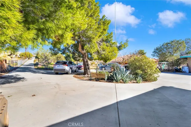 a view of road with card parked on the roadside