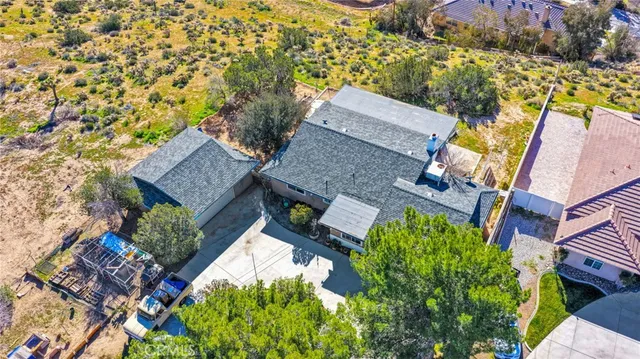 an aerial view of a house with a yard basket ball court and outdoor seating