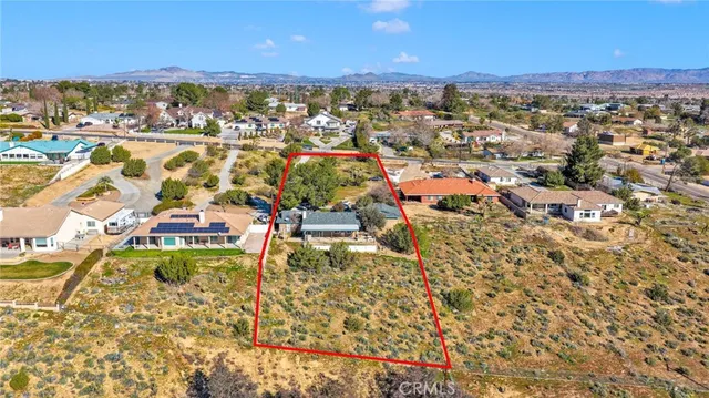an aerial view of residential houses with outdoor space and swimming pool