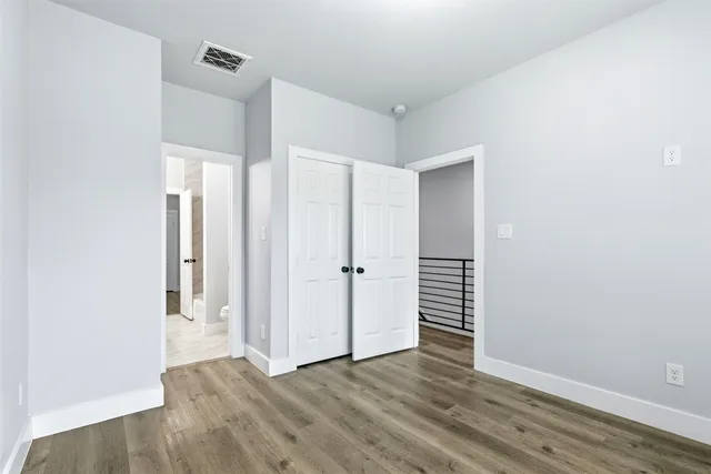 a view of wooden floor and windows in a room
