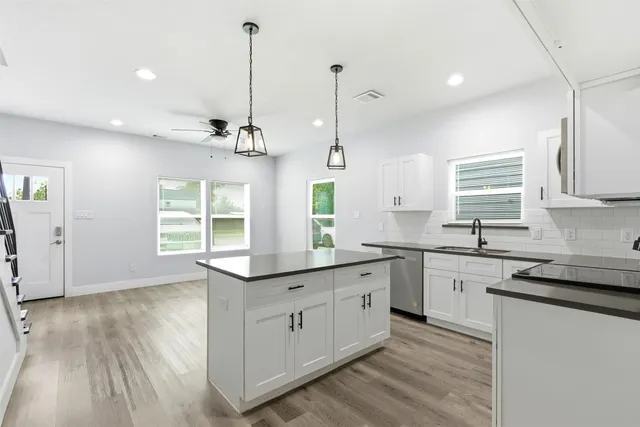 a kitchen with sink cabinets and window
