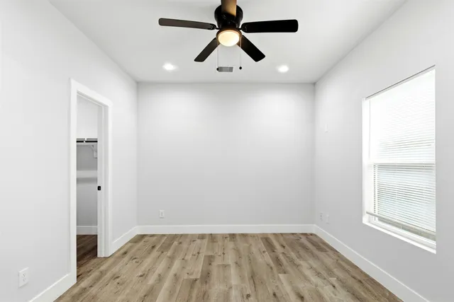 wooden floor in an empty room with a window