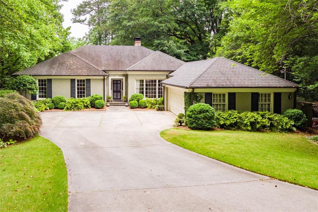 a front view of a house with a garden and porch