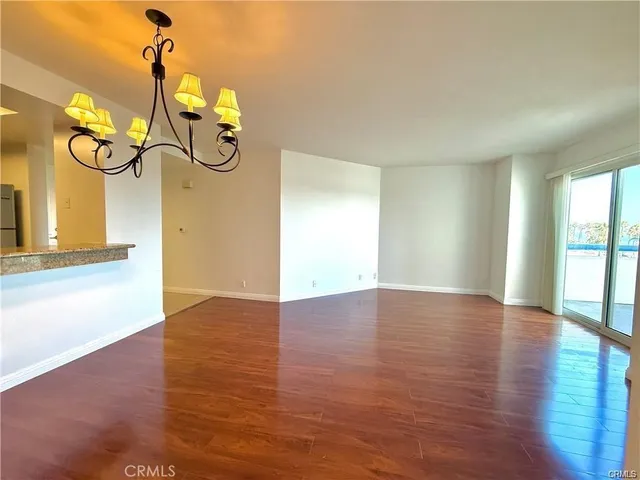 a kitchen with stainless steel appliances granite countertop a refrigerator a stove a sink and a microwave