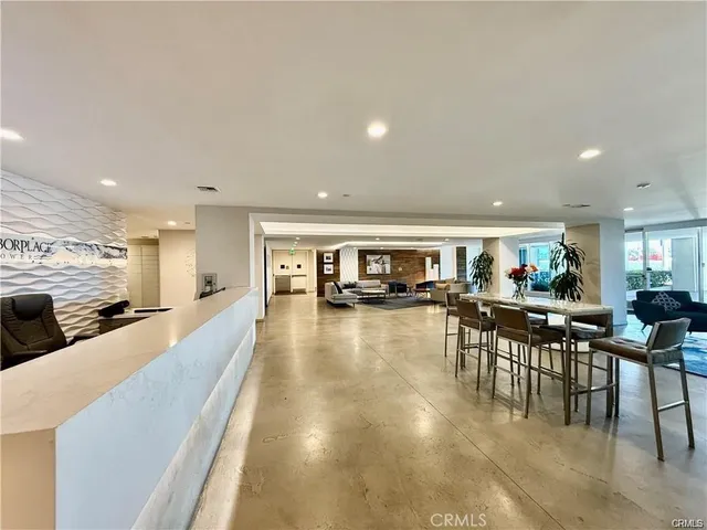 a living room with fireplace furniture and a large window