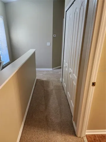 a white toilet and tub sitting next to a white cabinet