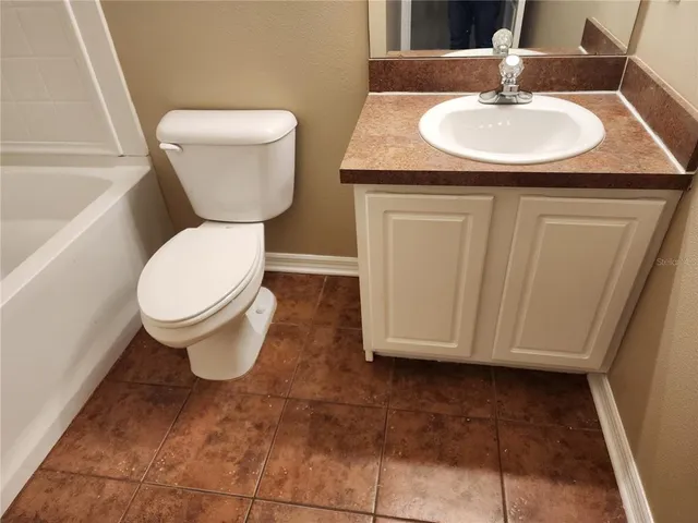 an empty room with a window and a ceiling fan