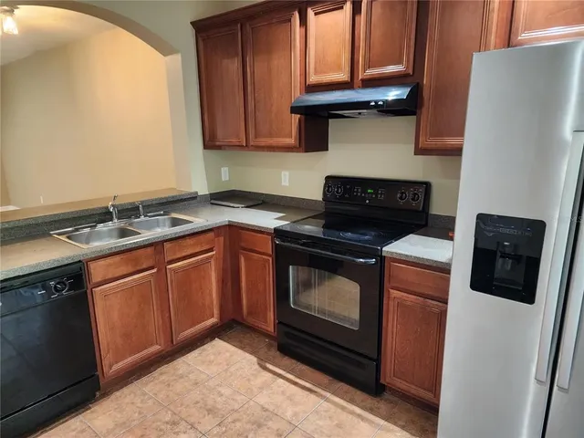 a stove top oven sitting inside of a kitchen
