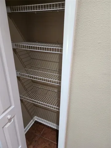 a bathroom with a granite countertop toilet and a sink