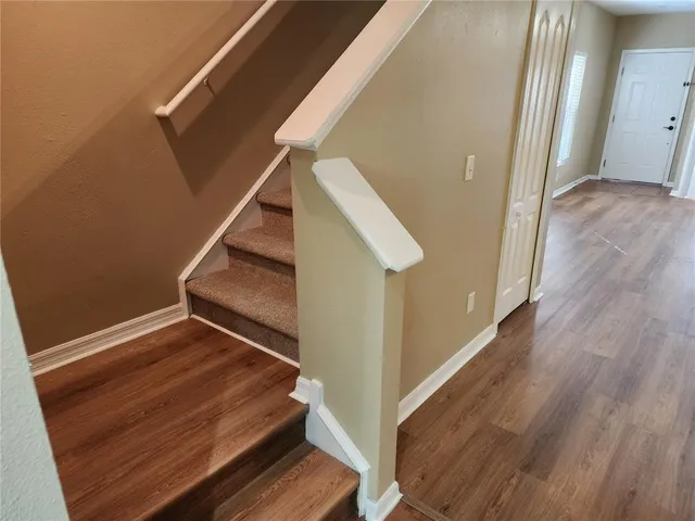 a view of an entryway with wooden floor and windows