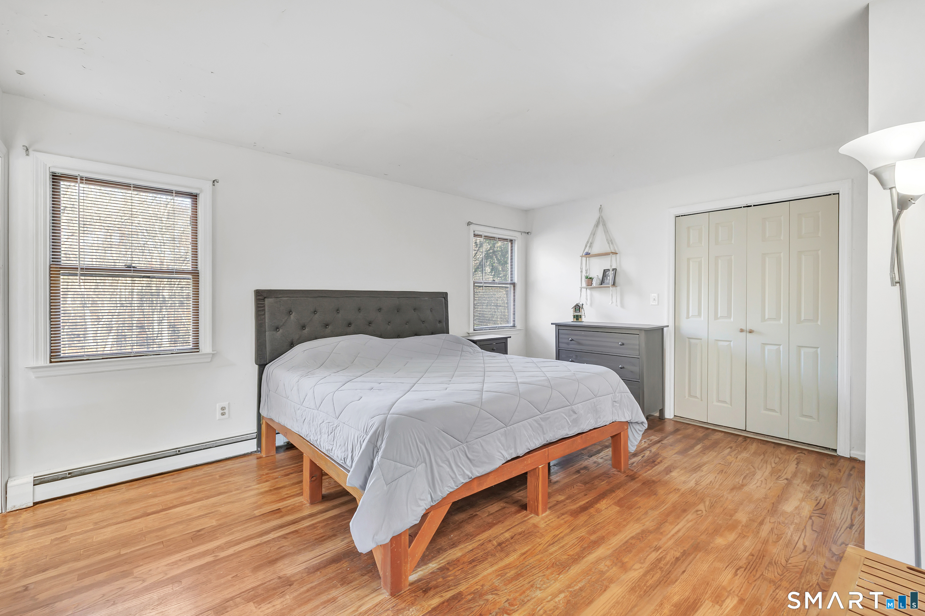 32 Autumn Ridge Road Milford, CT 06461 - Photo 18 of 40 a bedroom with a bed and wooden floor