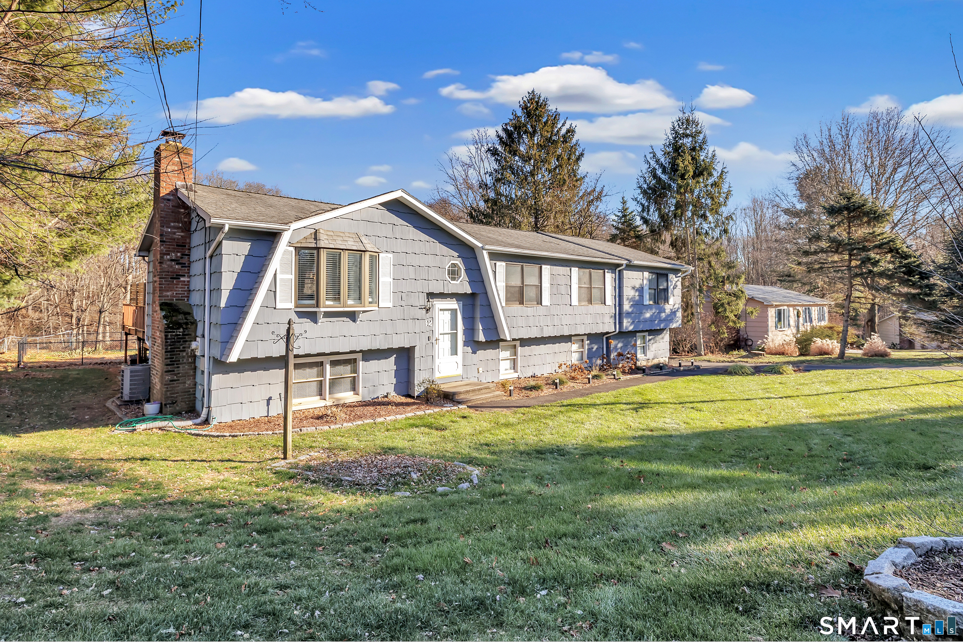 32 Autumn Ridge Road Milford, CT 06461 - Photo 2 of 40 a front view of a house with a yard table and chairs