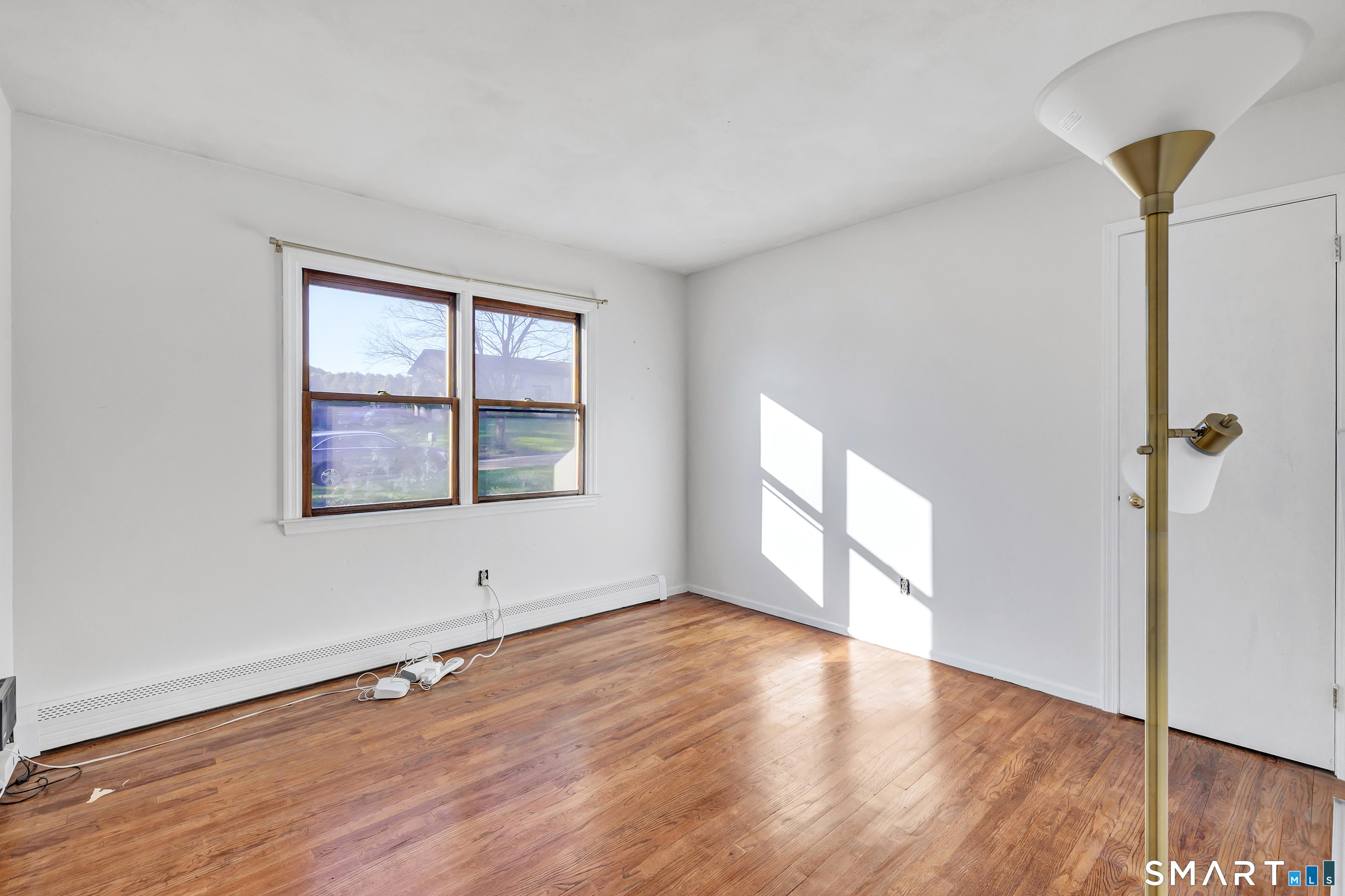 32 Autumn Ridge Road Milford, CT 06461 - Photo 22 of 40 an empty room with wooden floor and windows