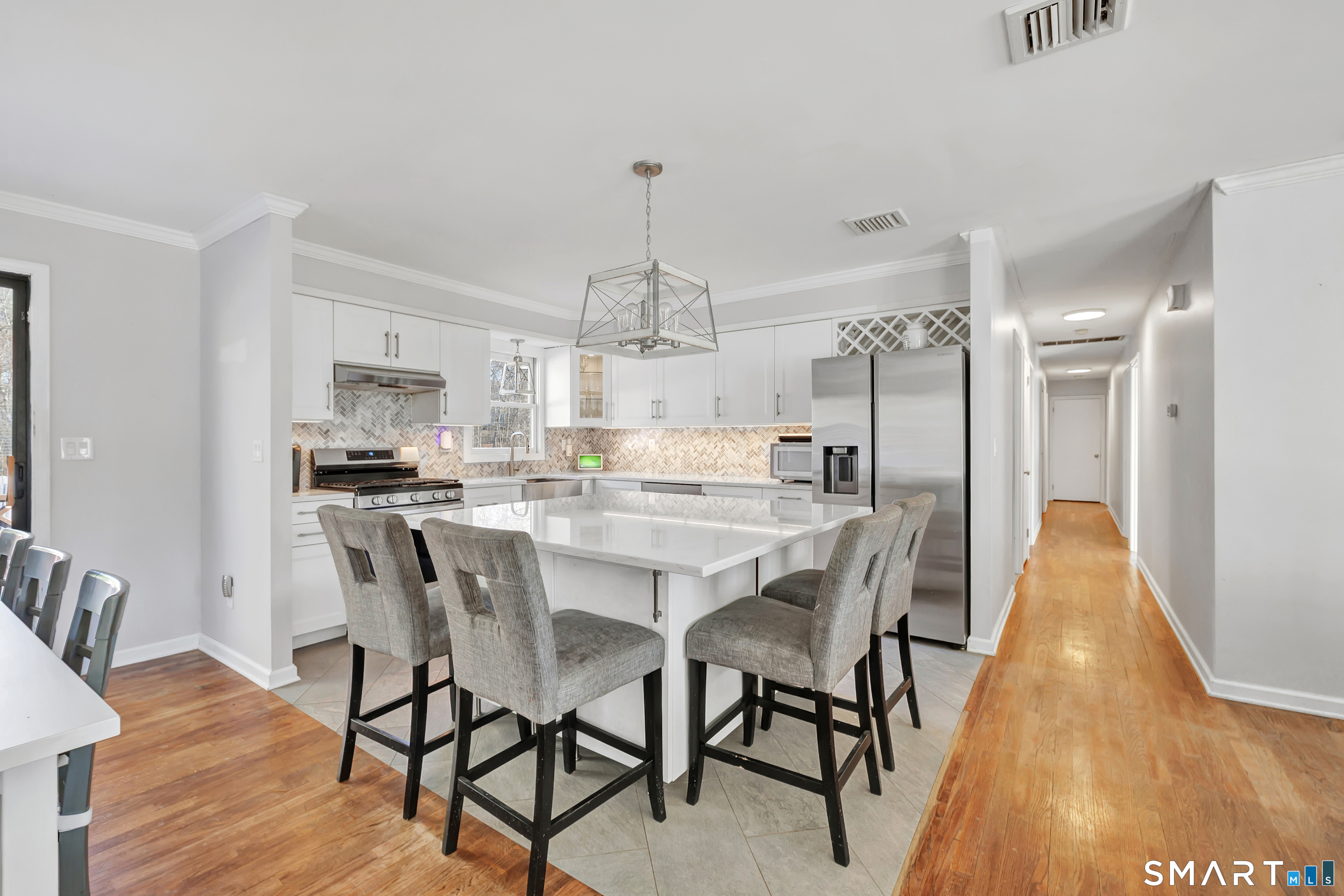 32 Autumn Ridge Road Milford, CT 06461 - Photo 6 of 40 a kitchen with stainless steel appliances a dining table chairs and wooden floor