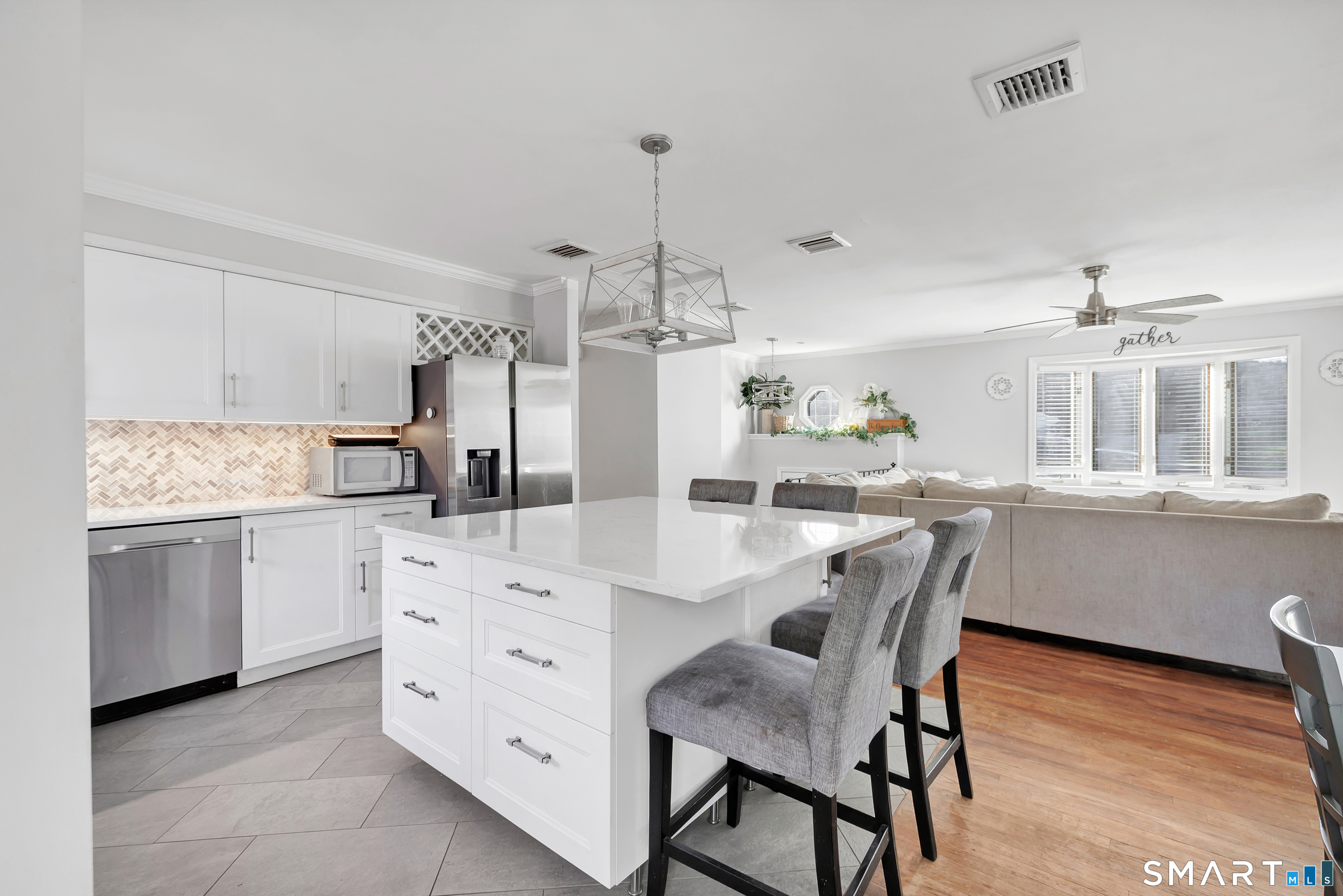 32 Autumn Ridge Road Milford, CT 06461 - Photo 7 of 40 a kitchen with cabinets a sink dishwasher a dining table and chairs