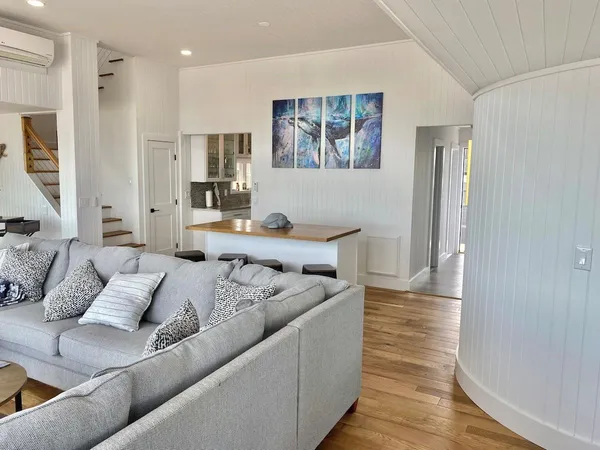 a living room with furniture and a wooden floor