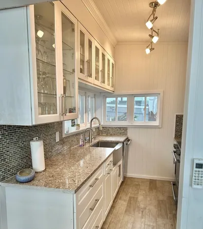 a kitchen with granite countertop a sink and a window