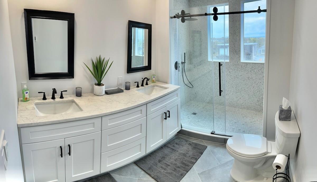 240 Wilmot Road Ocean Beach, NY 11770 - Photo 8 of 9 a bathroom with a double vanity sink toilet and shower