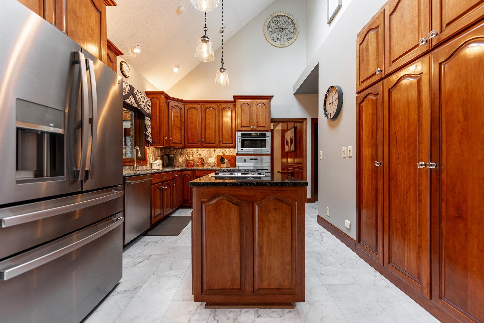 8161 Killarney Aire Road Roscoe, IL 61073 - Photo 14 of 53 a kitchen with stainless steel appliances granite countertop a refrigerator a sink and dishwasher