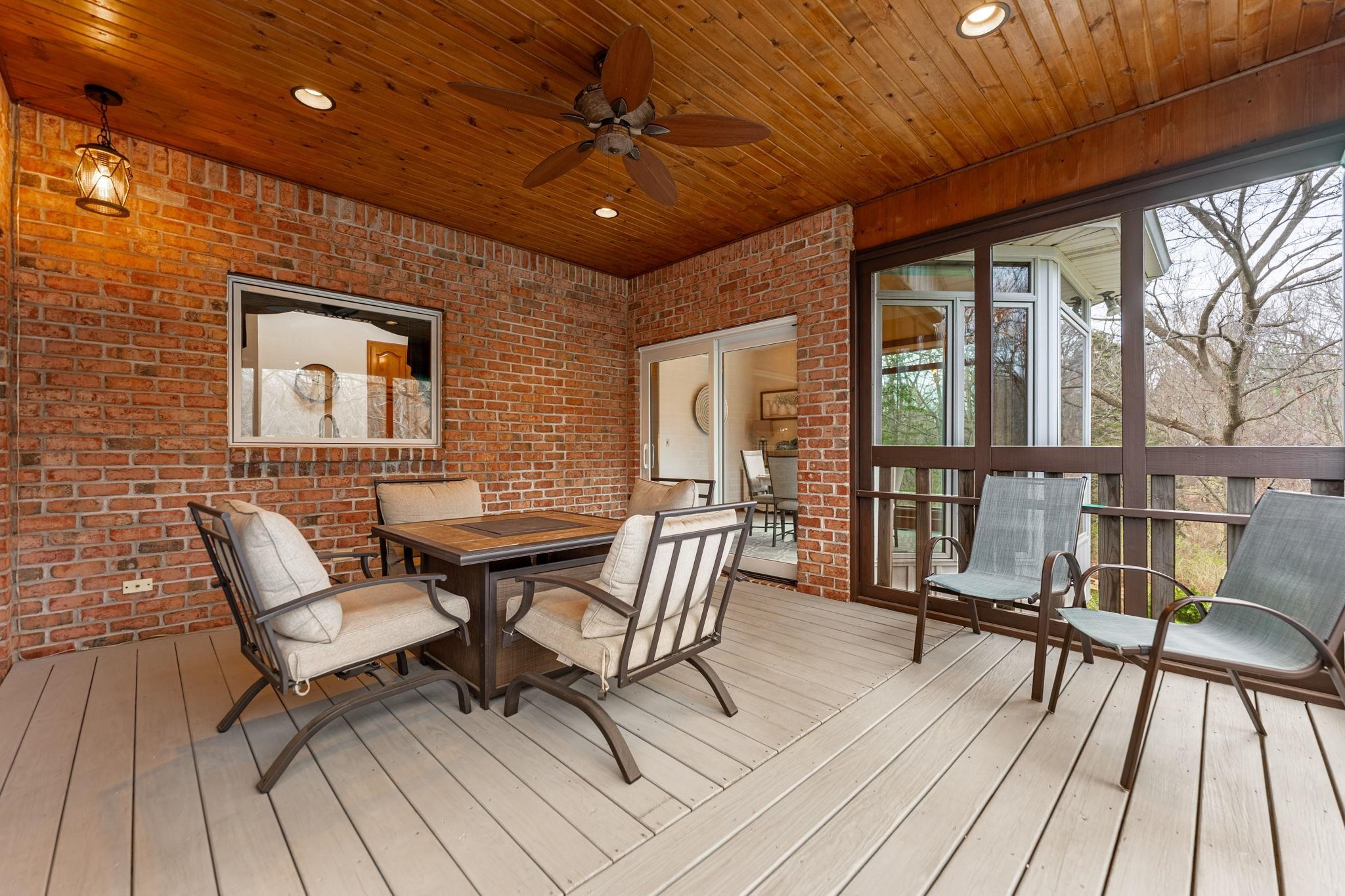 8161 Killarney Aire Road Roscoe, IL 61073 - Photo 18 of 53 a view of a patio with table and chairs and wooden floor