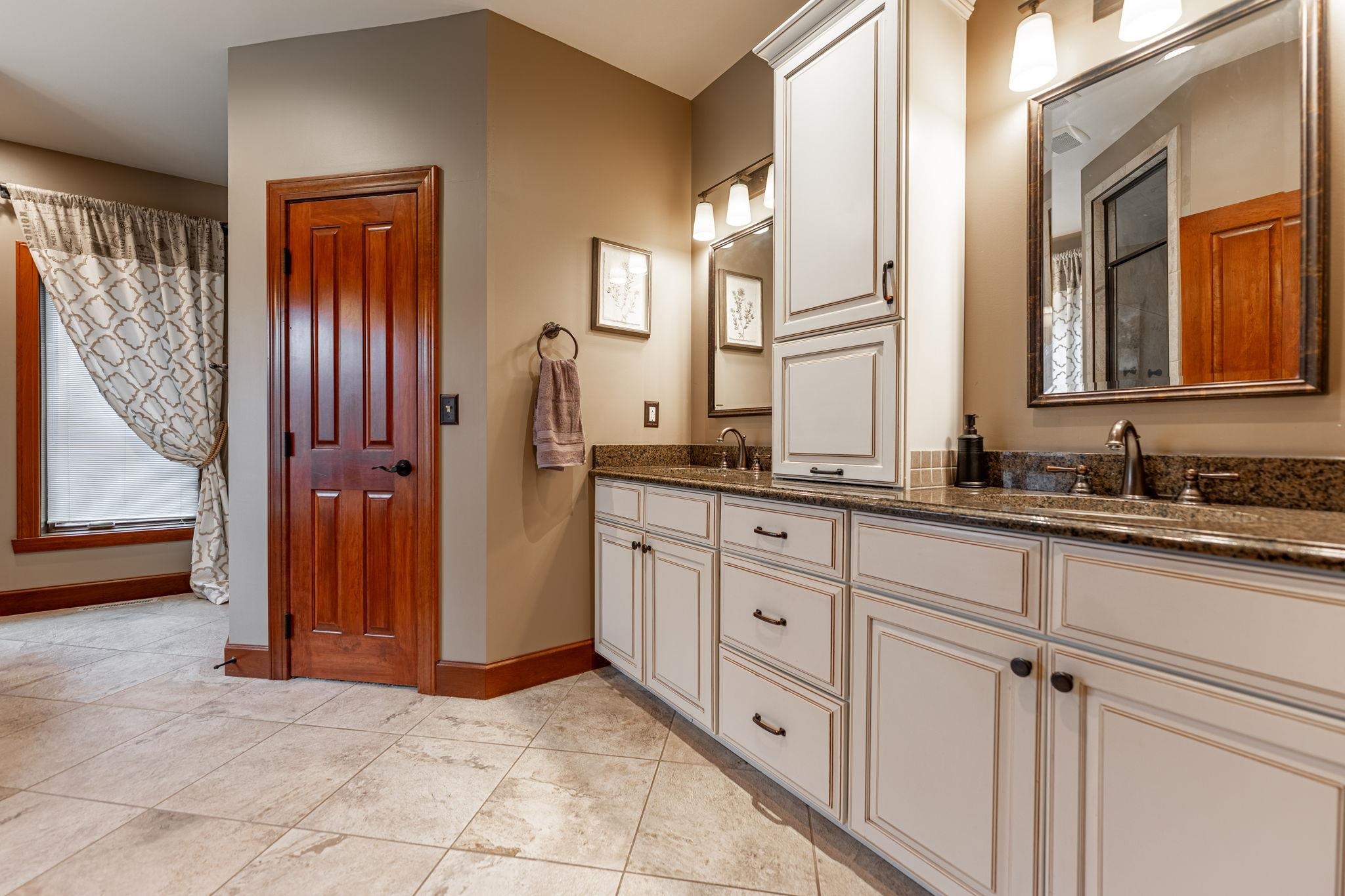 8161 Killarney Aire Road Roscoe, IL 61073 - Photo 22 of 53 a bathroom with a sink and a mirror