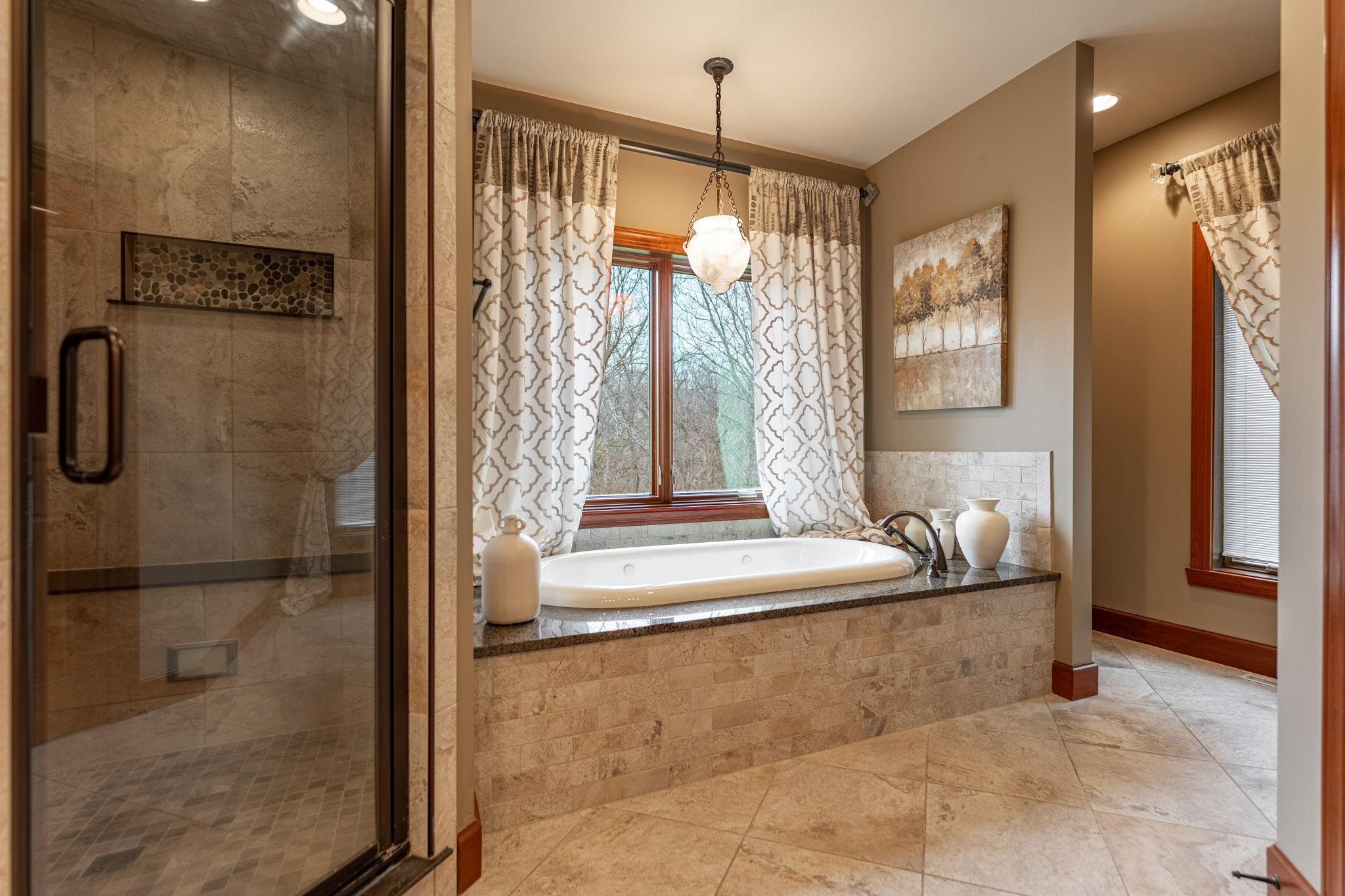8161 Killarney Aire Road Roscoe, IL 61073 - Photo 23 of 53 a bathroom with a granite countertop sink a mirror and shower