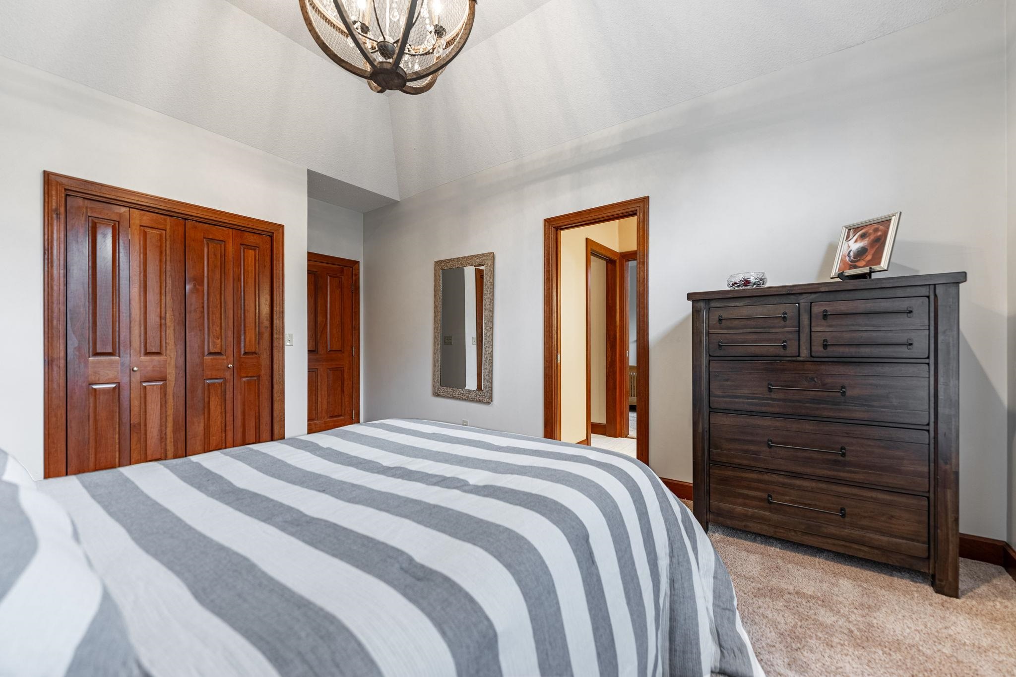 8161 Killarney Aire Road Roscoe, IL 61073 - Photo 27 of 53 a bedroom with a bed and a mirror