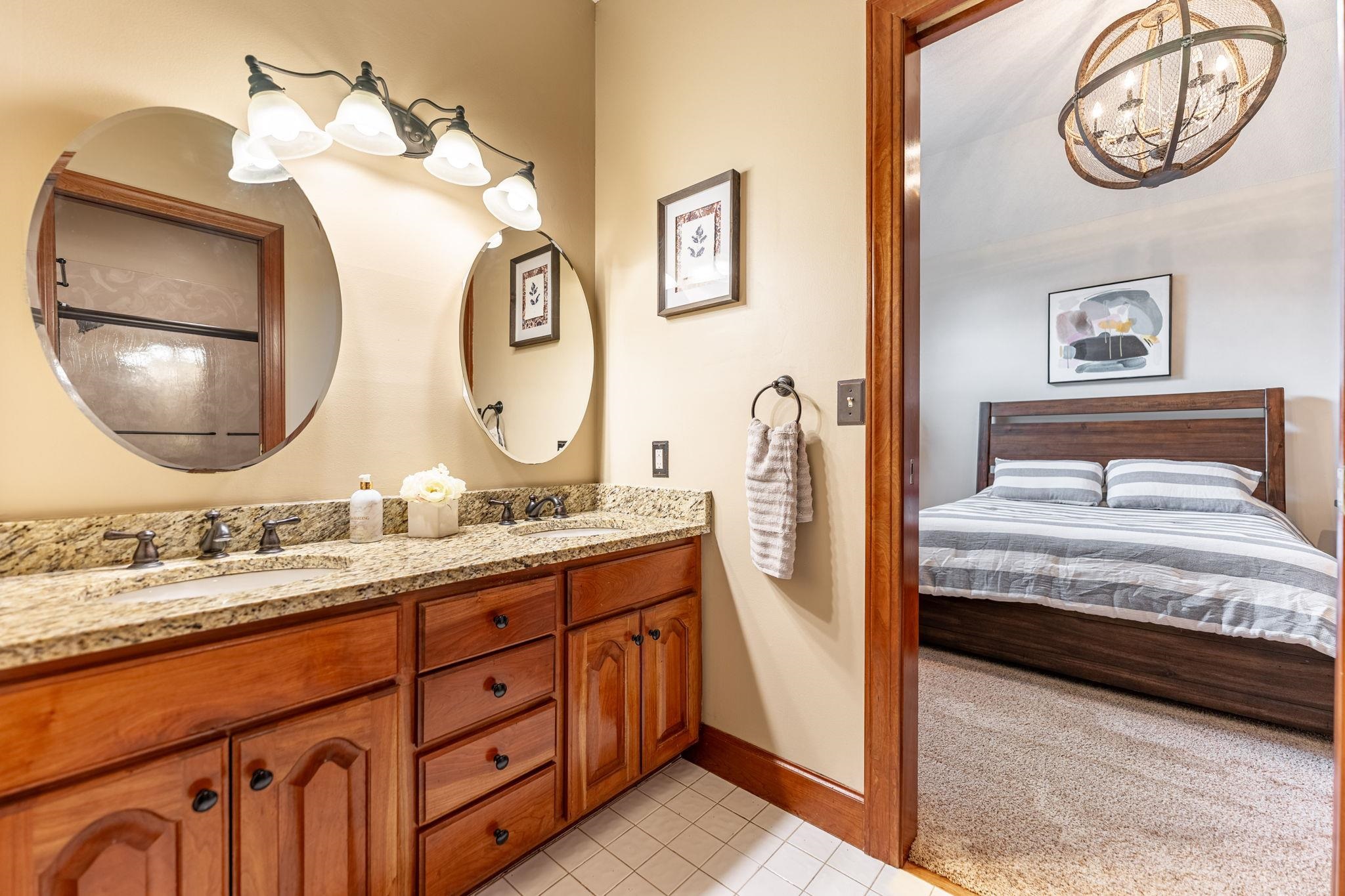 8161 Killarney Aire Road Roscoe, IL 61073 - Photo 28 of 53 a bathroom with a double vanity sink and a mirror