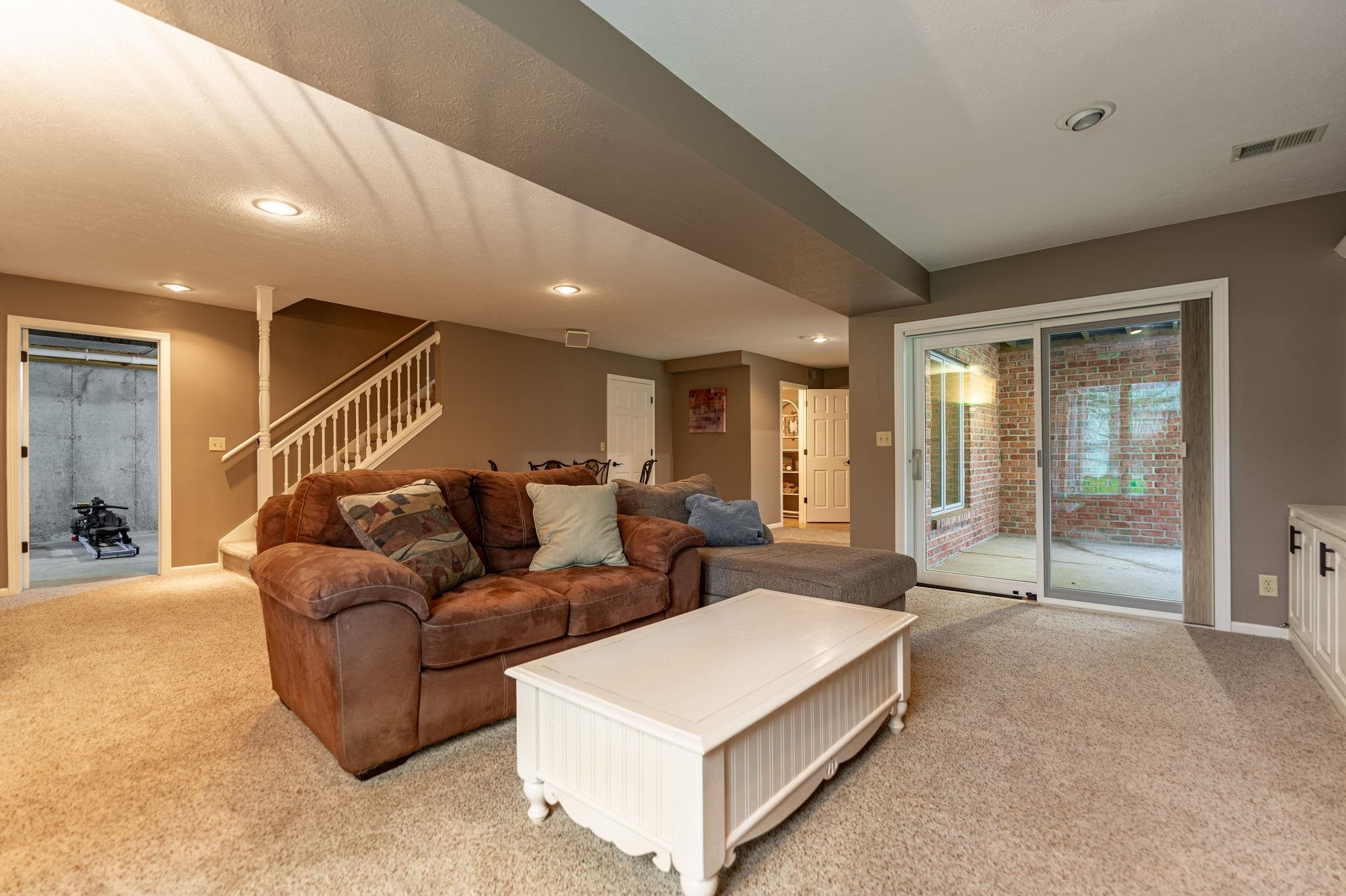 8161 Killarney Aire Road Roscoe, IL 61073 - Photo 32 of 53 a living room with furniture and large windows