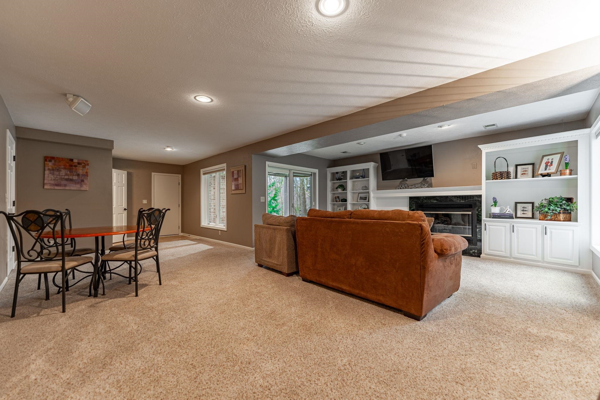 8161 Killarney Aire Road Roscoe, IL 61073 - Photo 33 of 53 a living room with furniture and a kitchen view