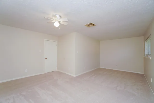 a view of an empty room with a fan