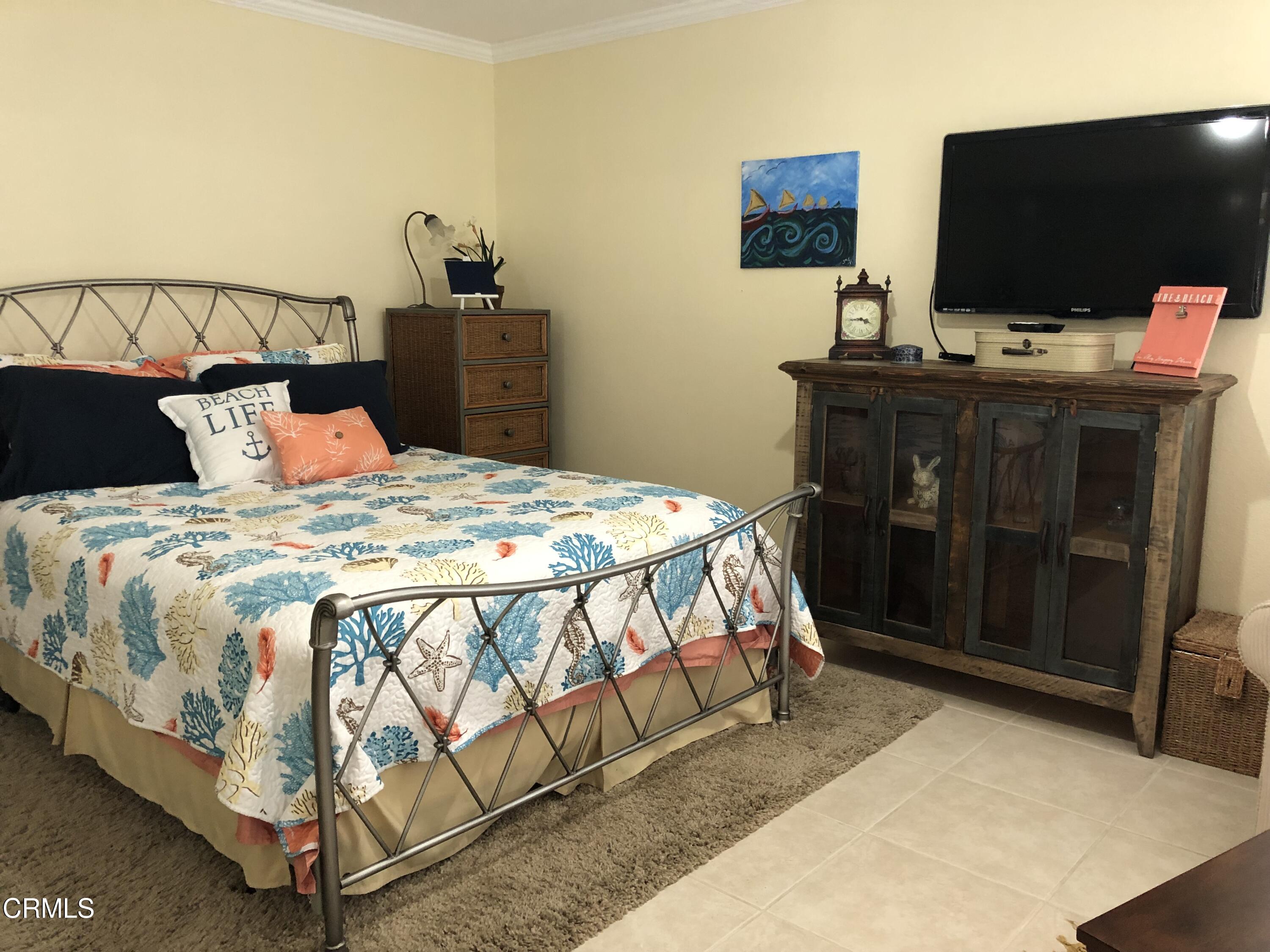 4962 Nautilus Street, Unit 1 Oxnard, CA 93035 - Photo 11 of 18 a bedroom with a bed and a flat screen tv