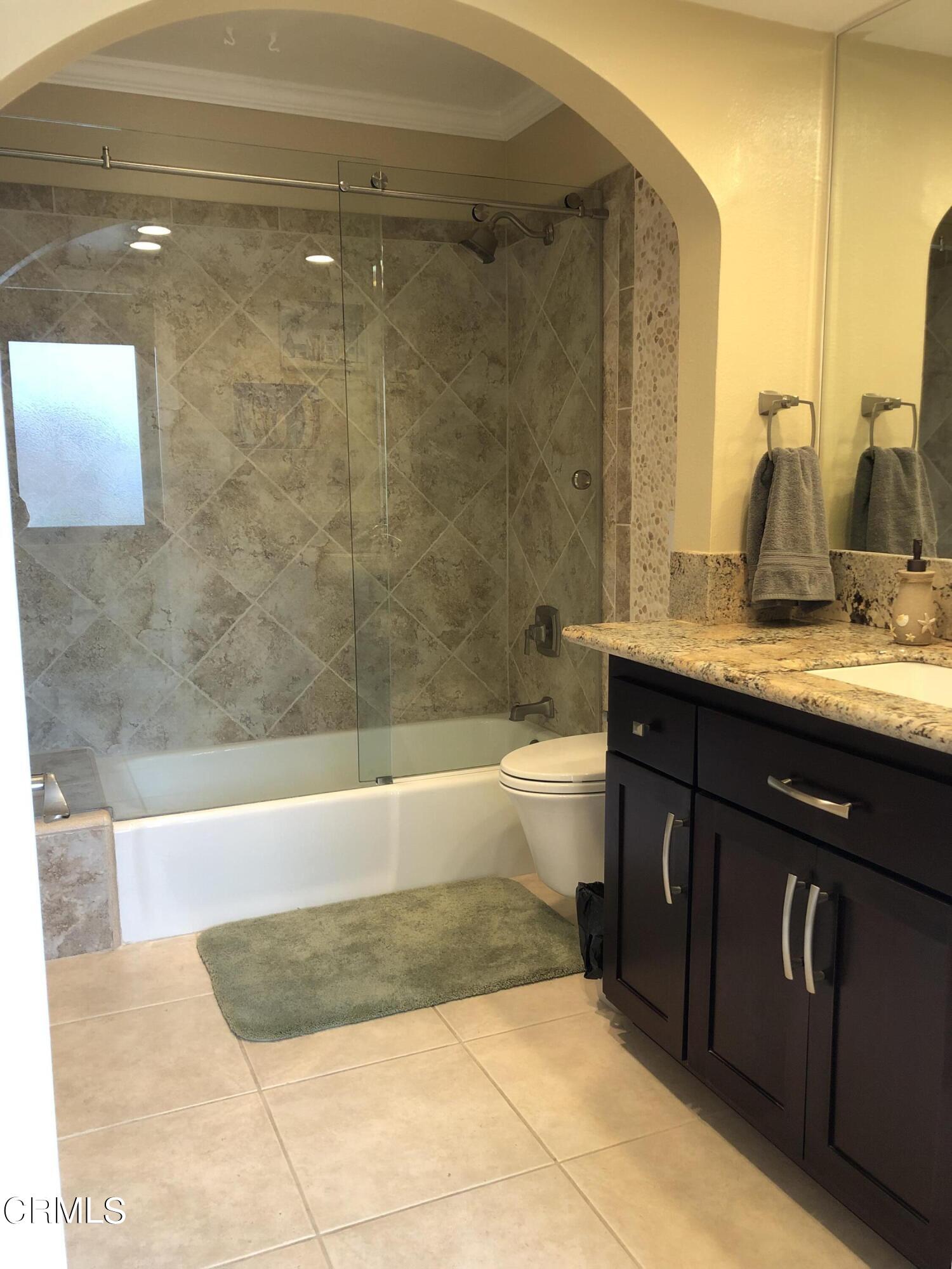 4962 Nautilus Street, Unit 1 Oxnard, CA 93035 - Photo 13 of 18 a bathroom with a bathtub and a sink