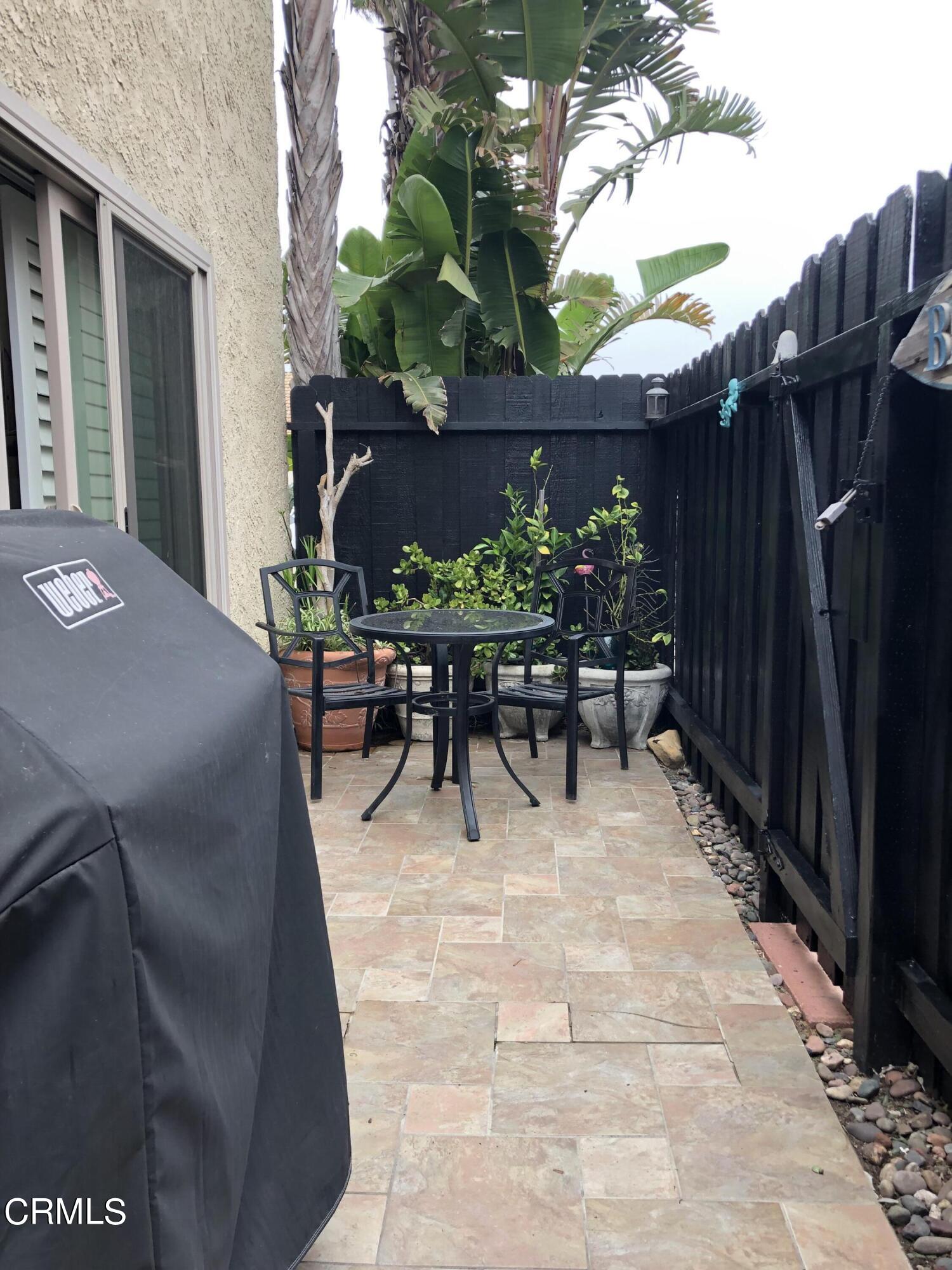 4962 Nautilus Street, Unit 1 Oxnard, CA 93035 - Photo 16 of 18 a view of a patio with table and chairs and potted plants