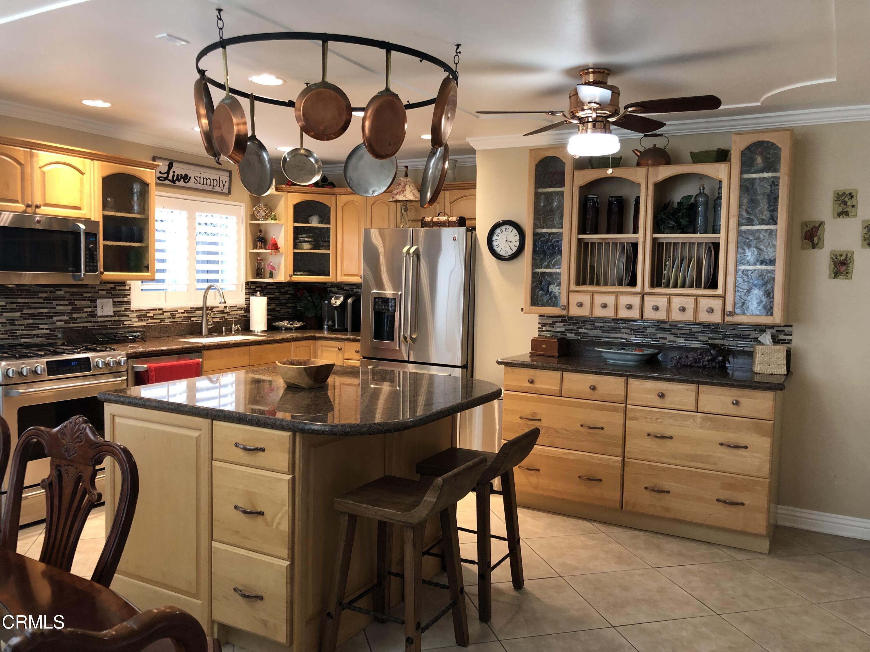 4962 Nautilus Street, Unit 1 Oxnard, CA 93035 - Photo 5 of 18 a kitchen with stainless steel appliances granite countertop a stove and cabinets