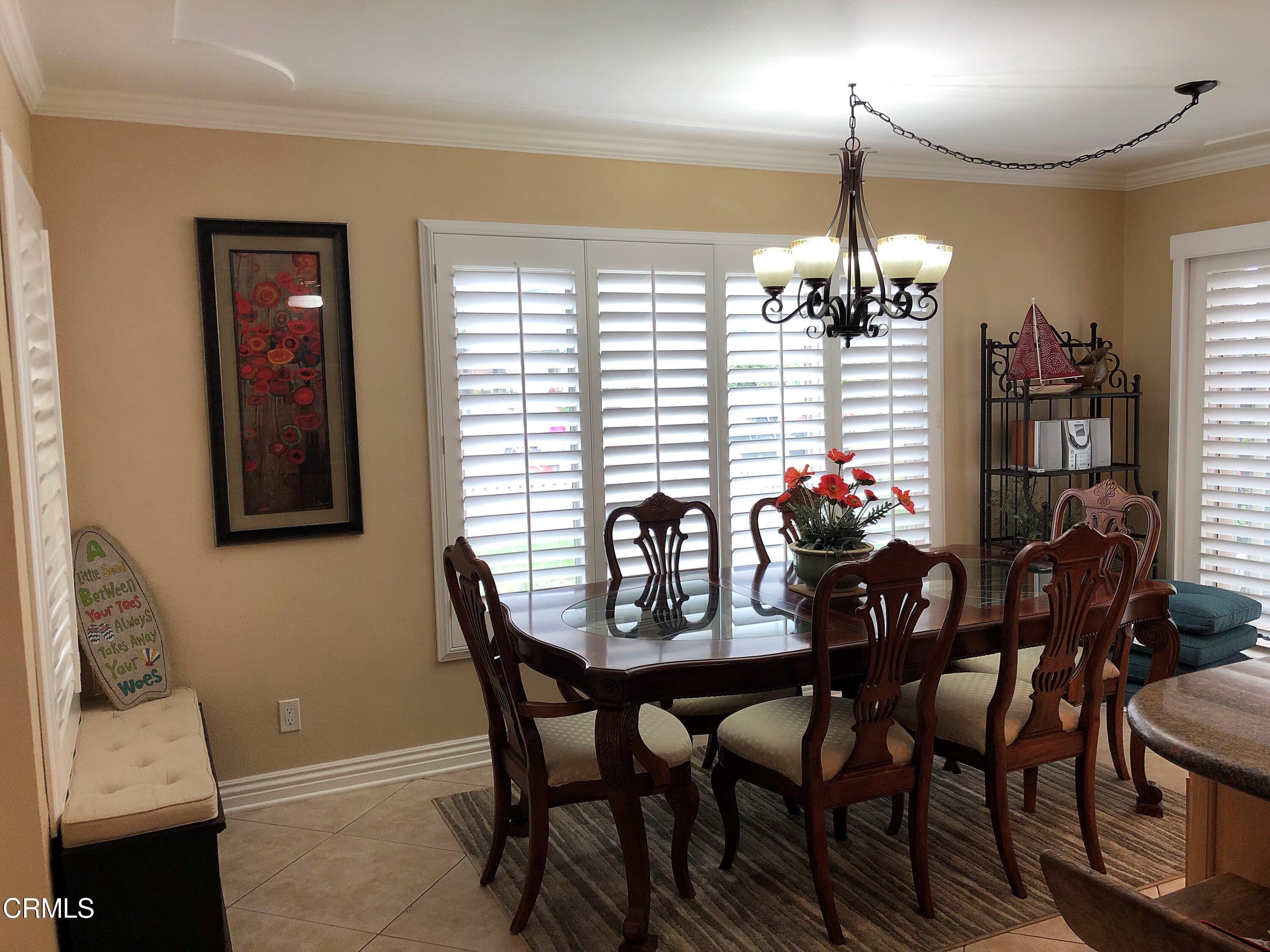 4962 Nautilus Street, Unit 1 Oxnard, CA 93035 - Photo 7 of 18 a view of a dining room with furniture and chandelier