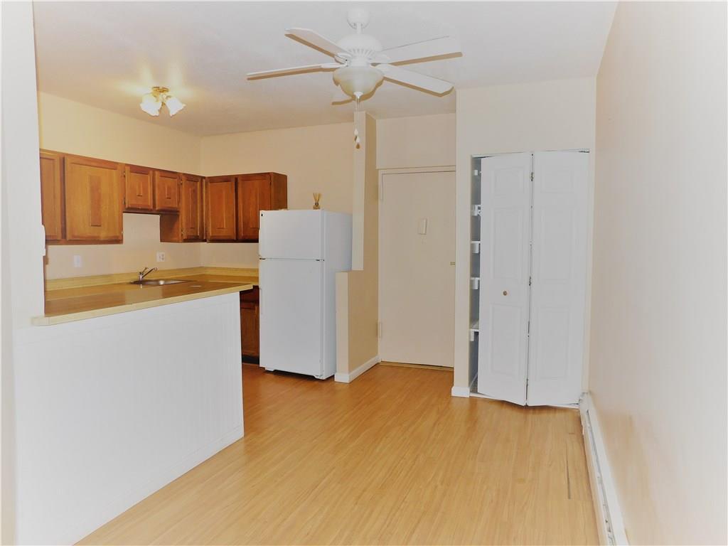 a room with a refrigerator and a sink