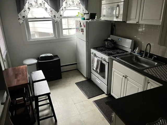 a kitchen with a sink appliances and cabinets