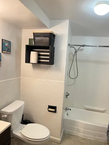 a bathroom with a toilet and a shower