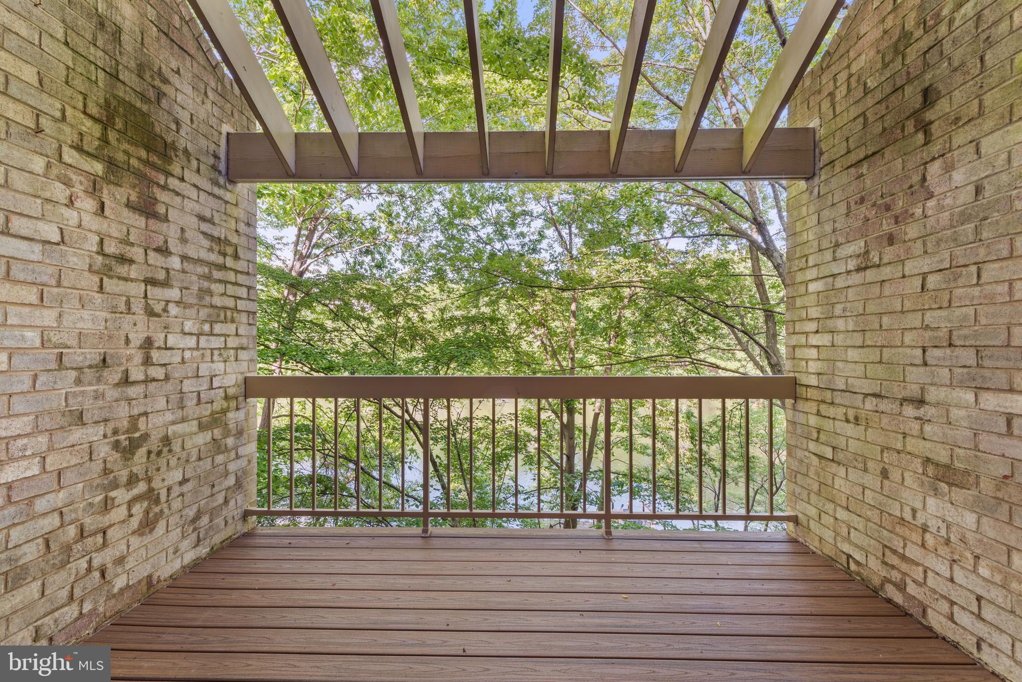 11116 Boathouse Court, Unit 93 Reston, VA 20191 - Photo 15 of 34 a view of a balcony with wooden floor and fence