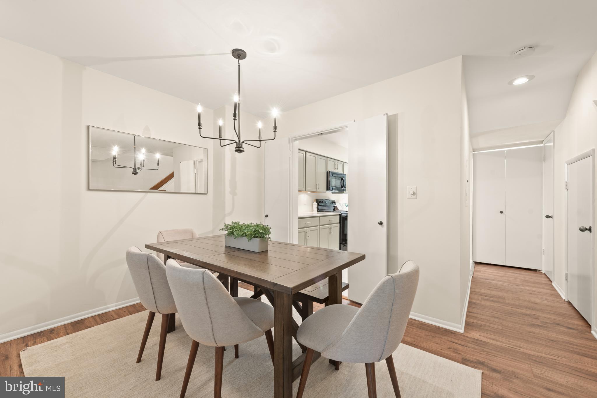 11116 Boathouse Court, Unit 93 Reston, VA 20191 - Photo 19 of 34 a view of a dining room with furniture wooden floor and chandelier