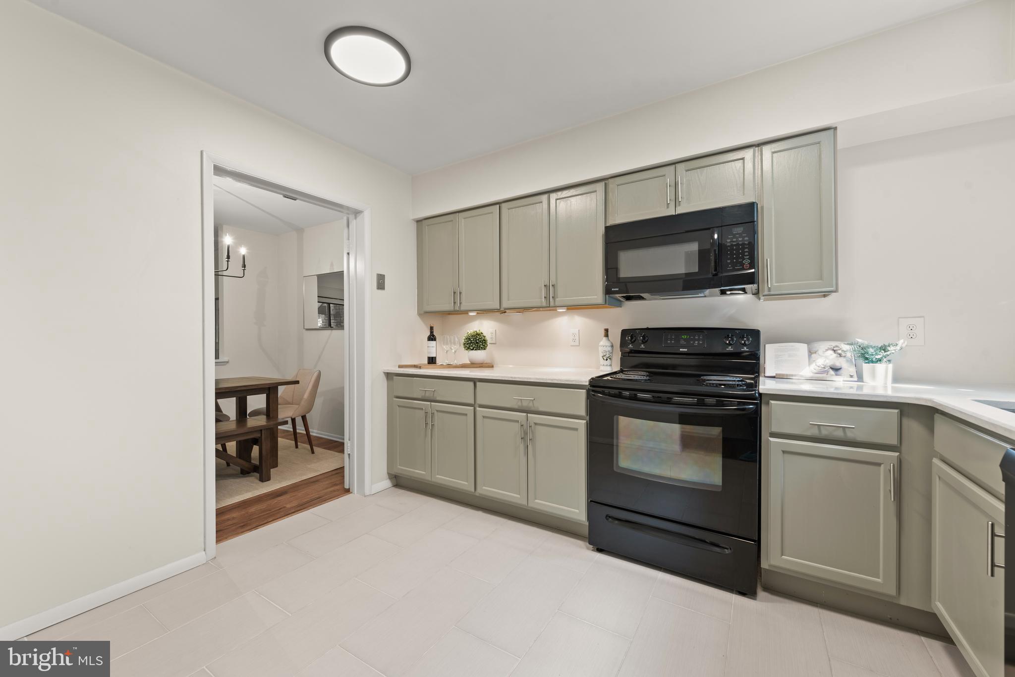 11116 Boathouse Court, Unit 93 Reston, VA 20191 - Photo 21 of 34 a kitchen with a sink stove and microwave
