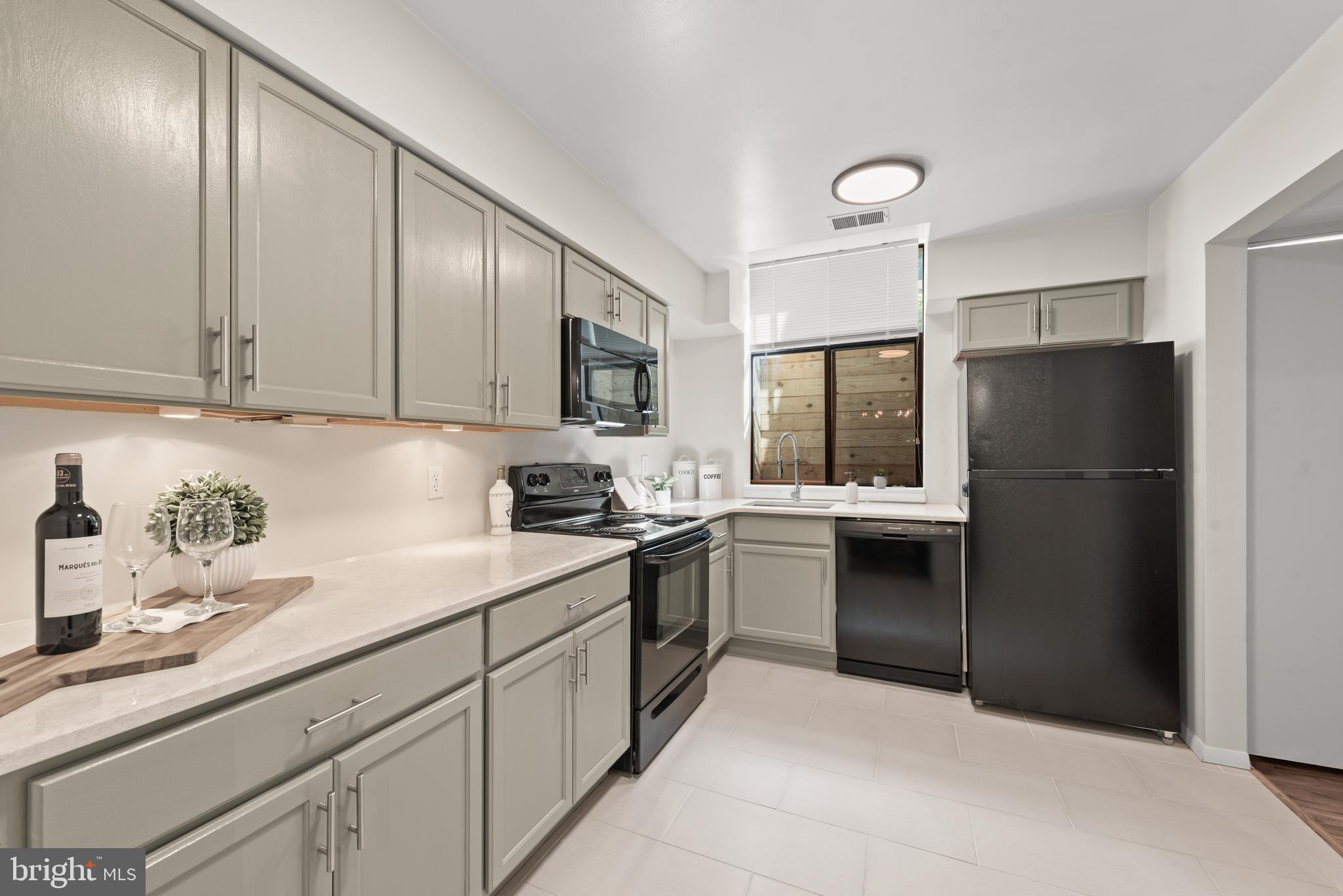 11116 Boathouse Court, Unit 93 Reston, VA 20191 - Photo 24 of 34 a kitchen with a refrigerator sink and cabinets