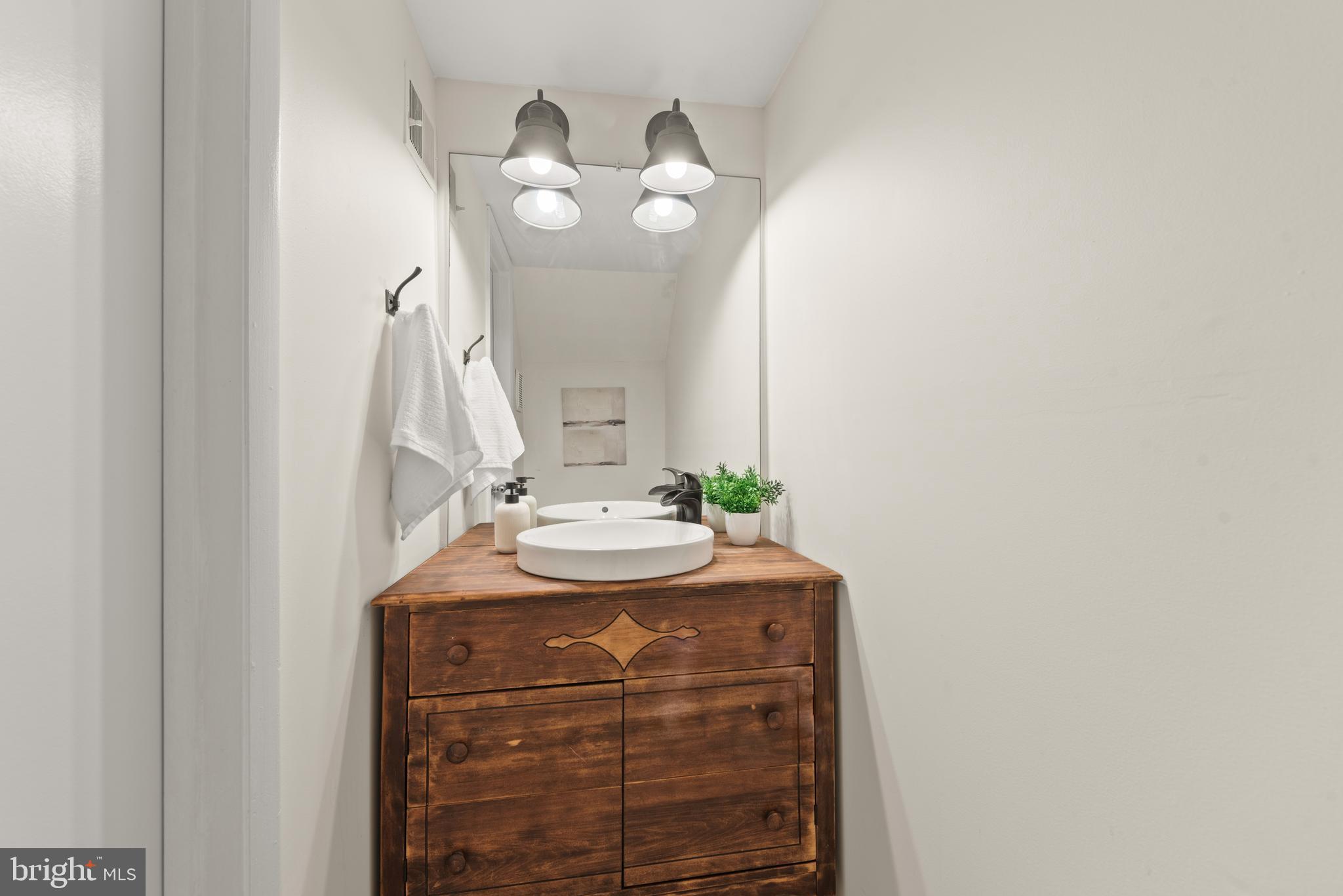 11116 Boathouse Court, Unit 93 Reston, VA 20191 - Photo 26 of 34 a bathroom with a sink and a mirror