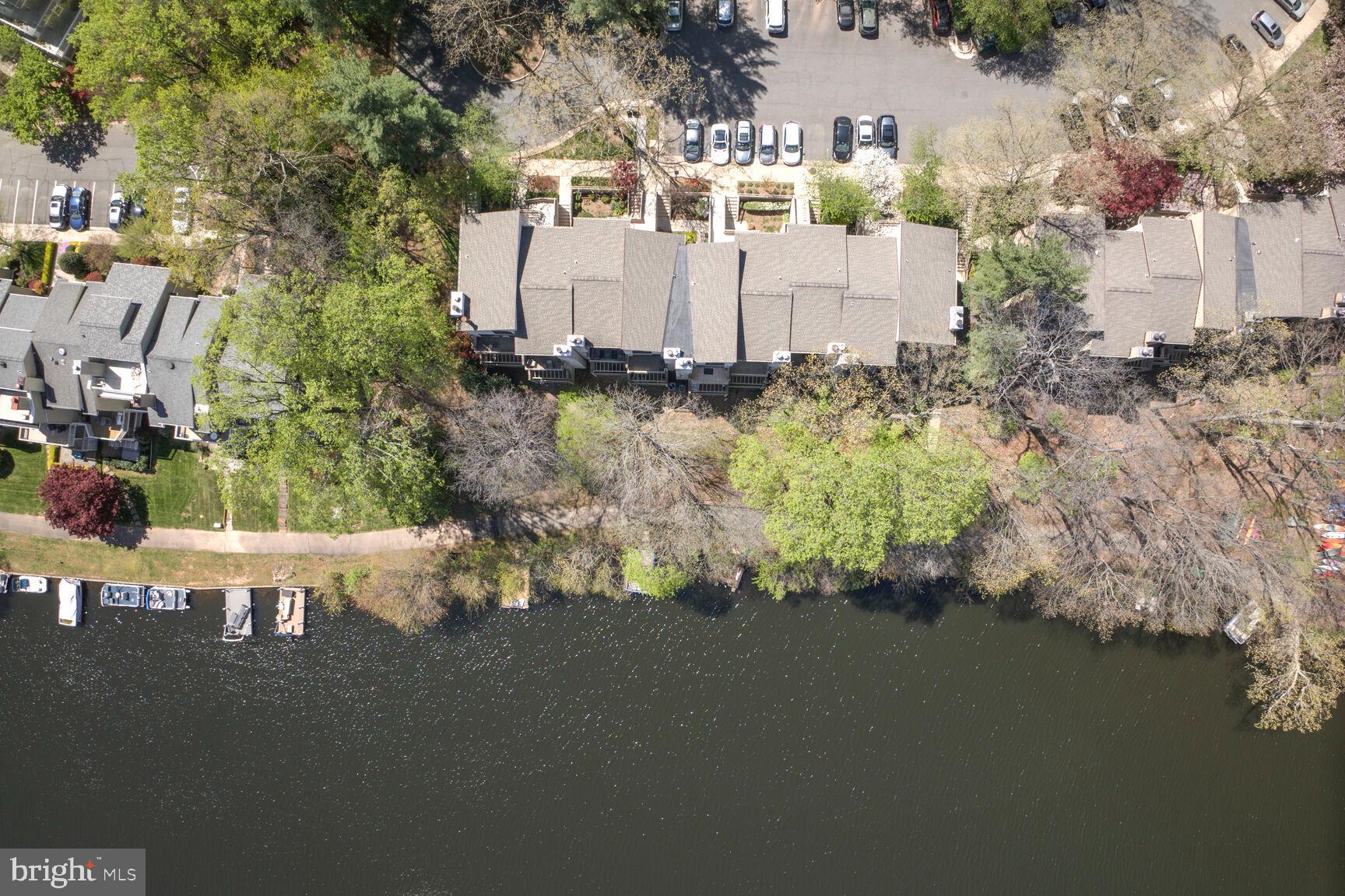 11116 Boathouse Court, Unit 93 Reston, VA 20191 - Photo 29 of 34 a view of a house with a yard and large trees