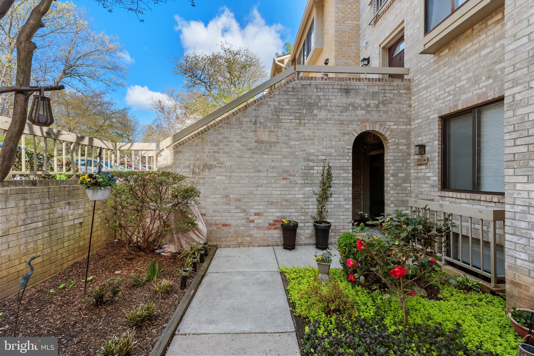11116 Boathouse Court, Unit 93 Reston, VA 20191 - Photo 3 of 34 a front view of a house with a garden
