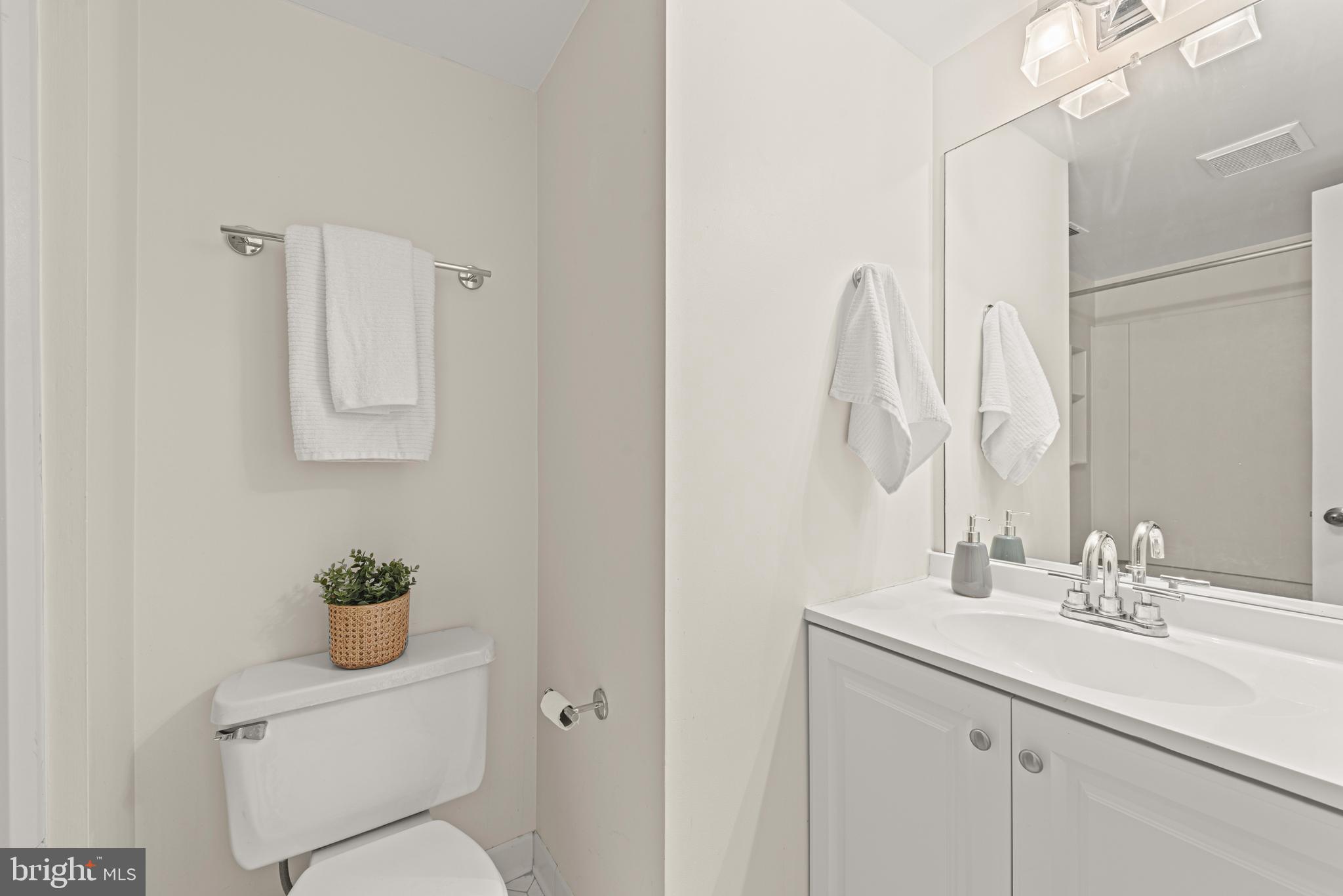 11116 Boathouse Court, Unit 93 Reston, VA 20191 - Photo 7 of 34 a bathroom with a sink a toilet and a mirror