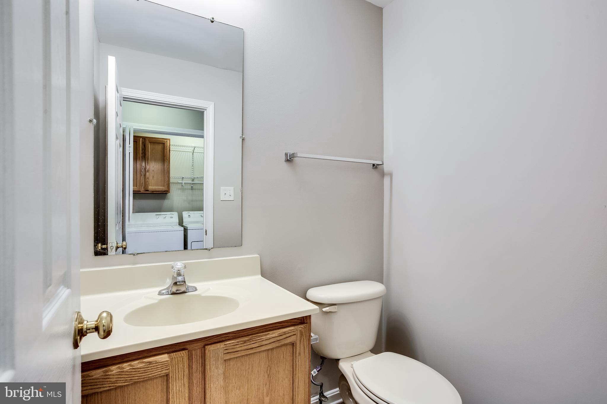 11506 Joseph Mill Road Silver Spring, MD 20906 - Photo 11 of 29 a bathroom with a sink toilet and mirror