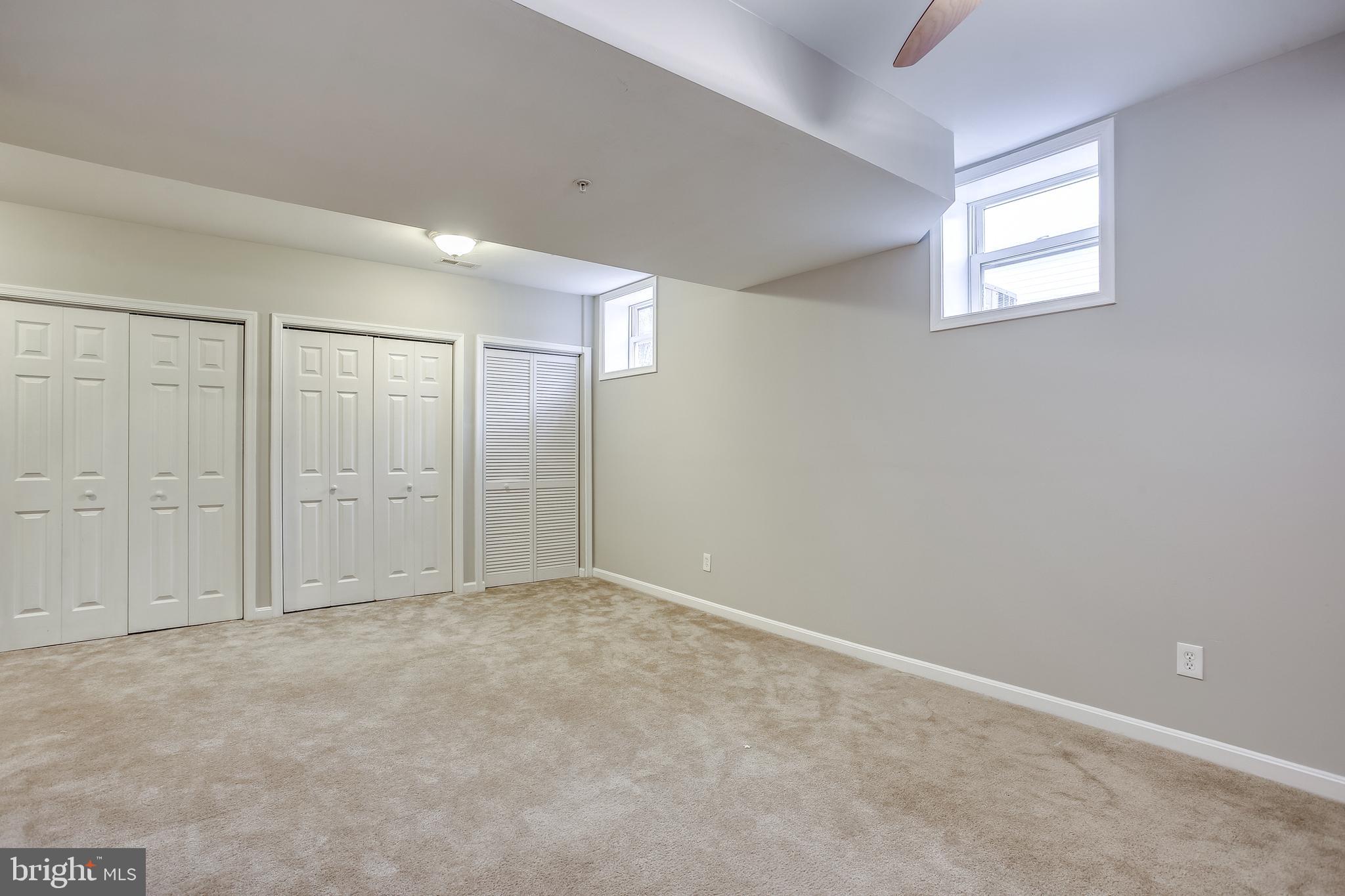 11506 Joseph Mill Road Silver Spring, MD 20906 - Photo 23 of 29 an empty room with windows and closet